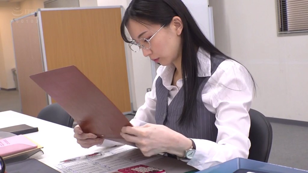 会社で自席に座り、仕事をしているシーン